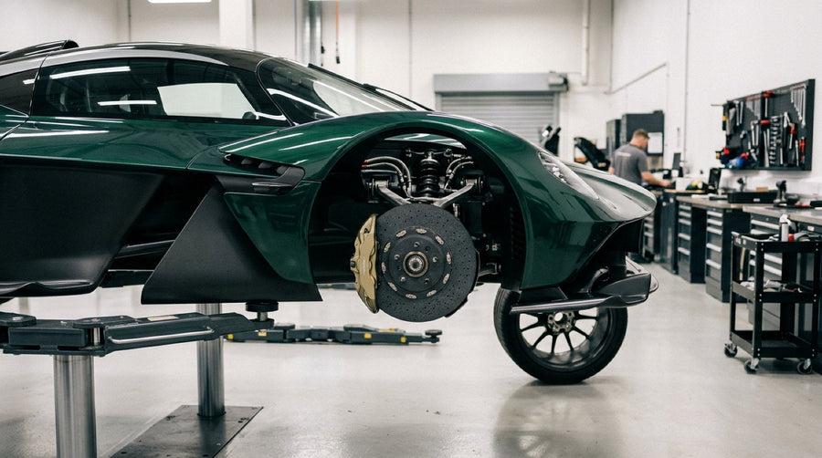 Lamborghini Revuelto wheel assembly showing large carbon ceramic brake rotor and caliper on a workshop lift
