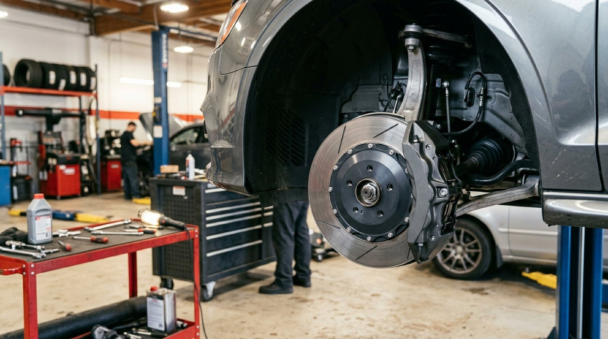 Four-piston caliper and disc assembly test fitted as an Audi Big Brake Kit in a workshop