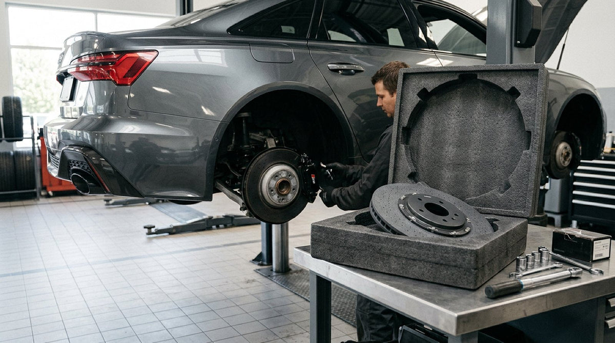 Audi sport brake hub assembly prepared for carbon ceramic rotor installation in a modern service bay