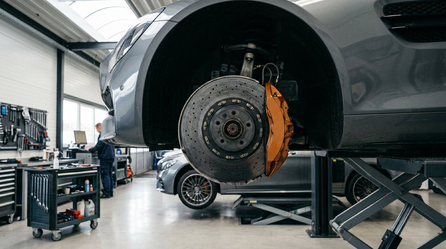 Front carbon ceramic brake rotor and gold caliper installed on a Mercedes-Benz AMG wheel hub.