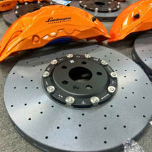 ForzaCCB carbon ceramic brake rotor paired with a bright orange Lamborghini Carboceramici brake caliper.
