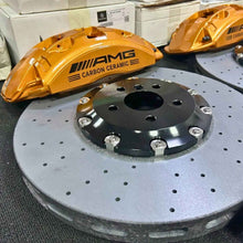 ForzaCCB carbon ceramic brake rotor paired with a signature bronze Mercedes AMG Carbon Ceramic brake caliper and OEM packaging.