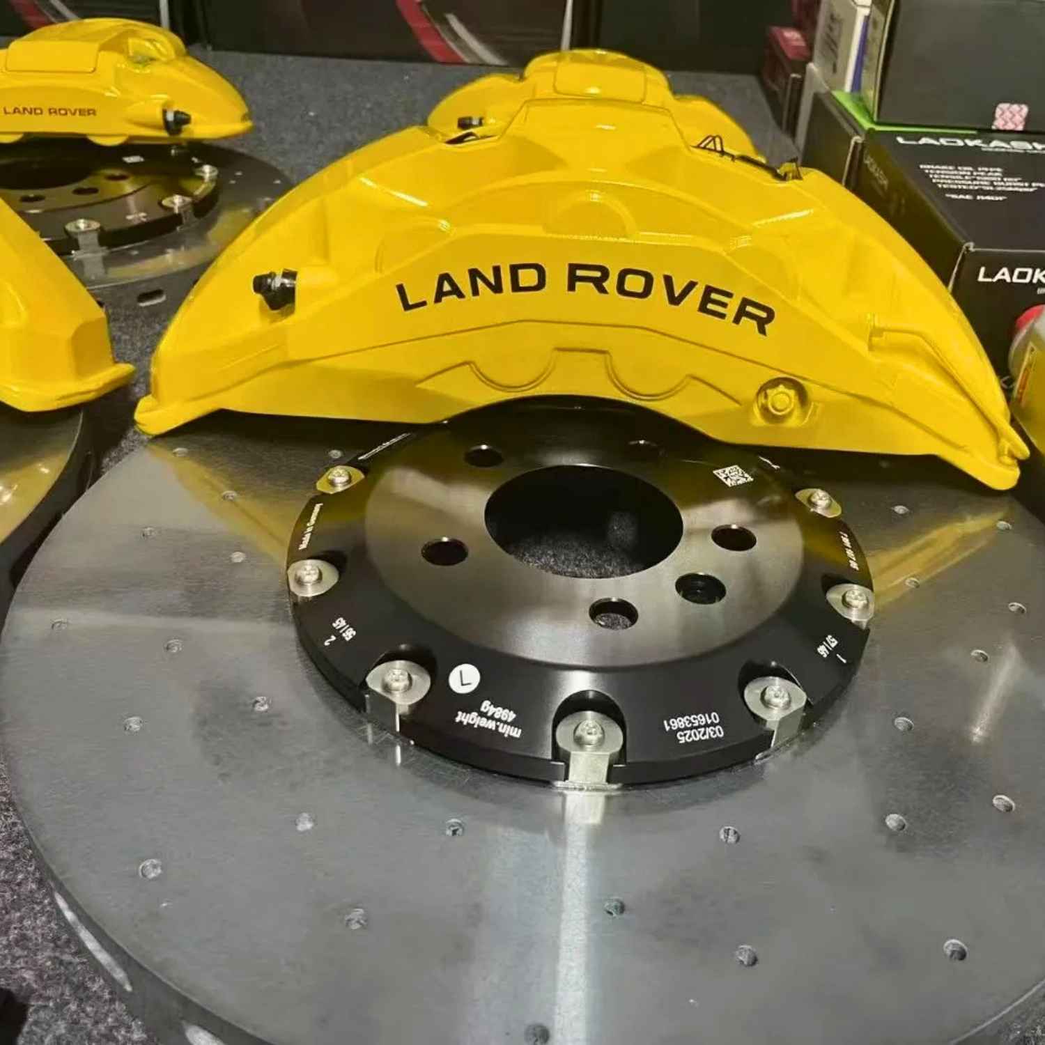 ForzaCCB carbon ceramic brake rotor paired with a yellow multi-piston Land Rover brake caliper.