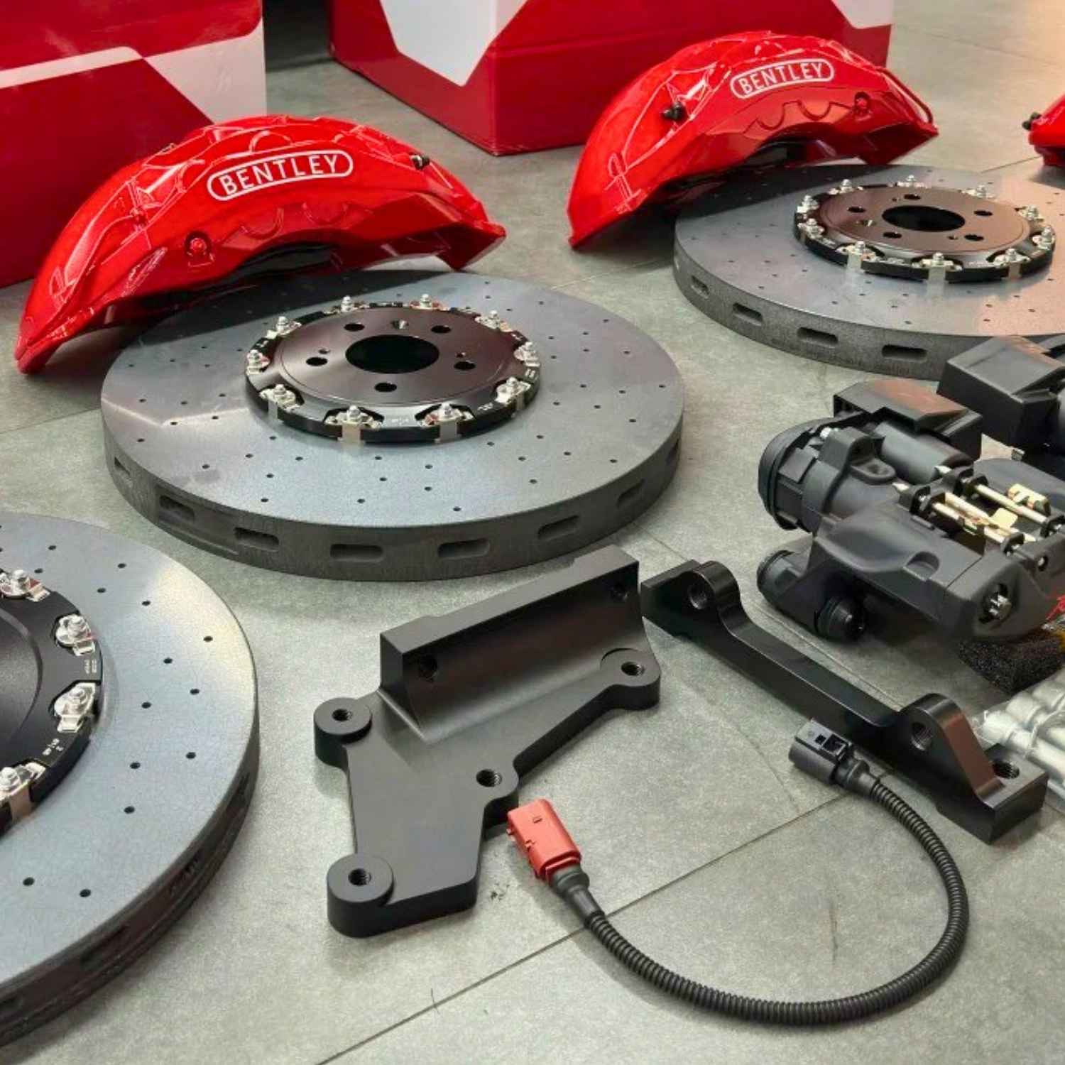 Complete ForzaCCB carbon ceramic brake kit for Bentley, featuring red front calipers, rear EPB calipers, custom brackets, and carbon ceramic rotors.