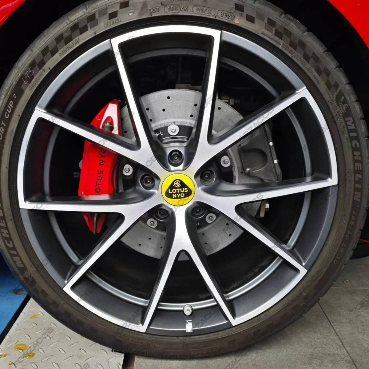 Pair of ForzaCCB carbon ceramic brake rotors showcased with bright red Alcon RCZ forged 6-pot brake calipers.