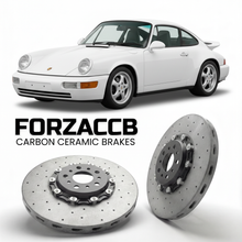 ForzaCCB direct OEM replacement carbon ceramic brake rotors for 1989 to 1994 Porsche 911 Carrera 2 models, shown with a white Porsche 911 Carrera 2 car.