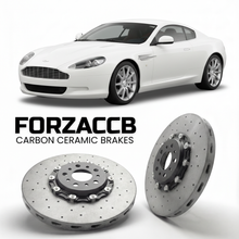ForzaCCB direct OEM replacement carbon ceramic brake rotors for 2004 to 2012 Aston Martin DB9 VH models, shown with a white Aston Martin DB9 car.