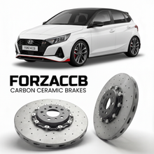 ForzaCCB direct OEM replacement carbon ceramic brake rotors for 2021 to 2026 Hyundai i20 N Line models, shown with a white Hyundai i20 N Line car.